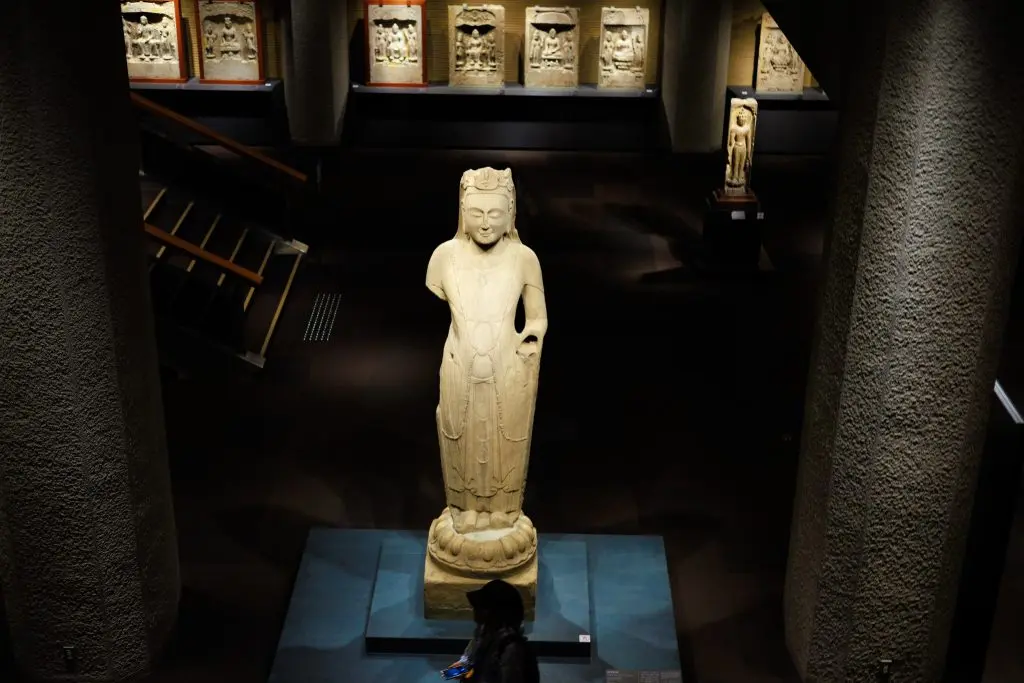 Standing Buddhist stone sculpture
